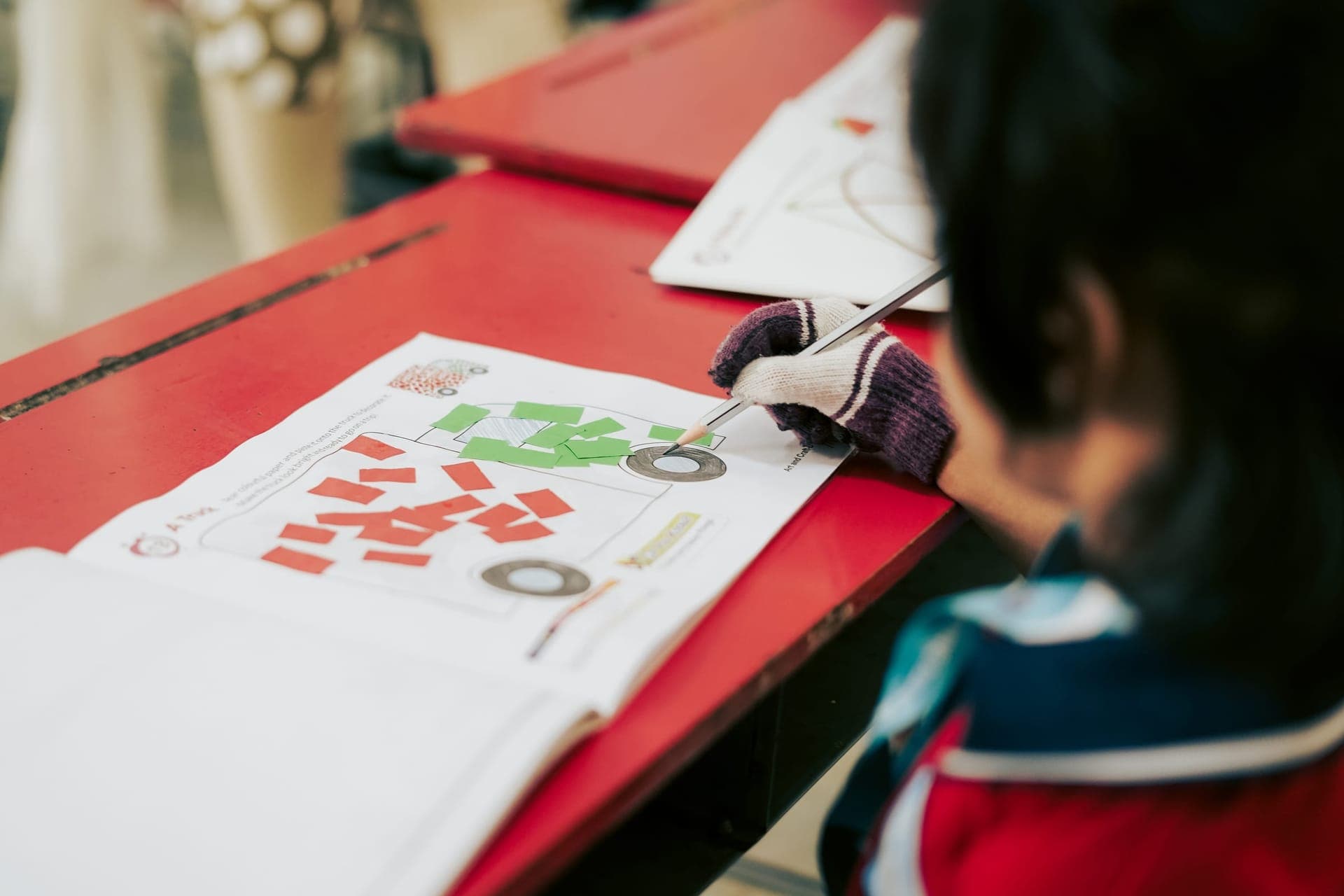 A student working on an art and craft project at their desk