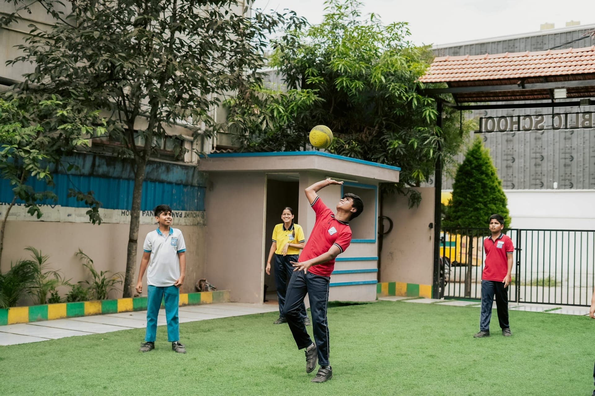 Students playing throwball on the school grounds
